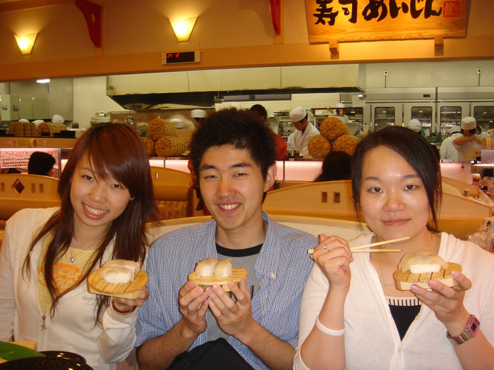 Jessica, Satoshi, and Michelle with the sushi they won