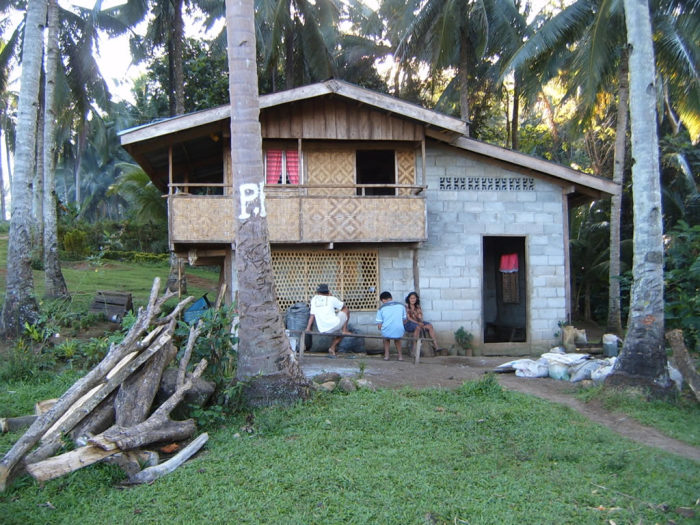 Jorge and Melvin survey one of the wealthier local families. They have children in Manila sending back money to pay for this house.
