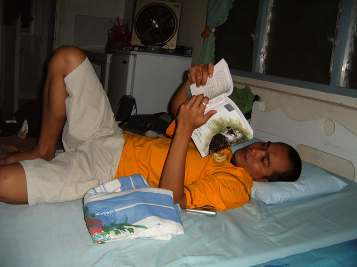 Melvin reading "Birds of the Philippines", a colossal tome. Sadly, most of the birds listed therein are threatened or endangered.