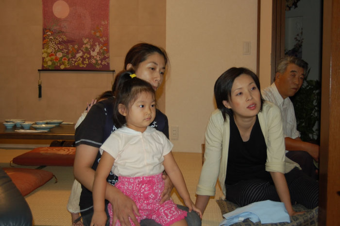 The extended Murakami family listens to my parents' travel recap.