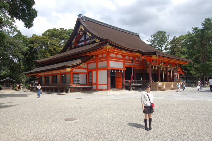 Shinto shrine main building - note the three large ropes for ringing the bells after offering money.