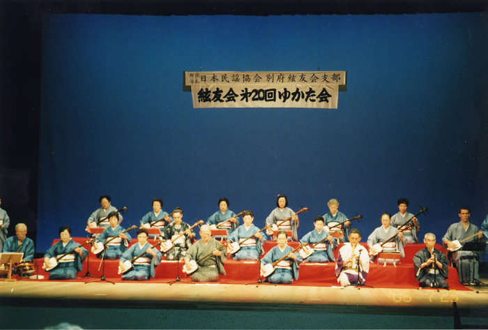 Group shot of the shamisen troupe madly shredding in their Gucci linens.